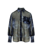 A sheer long-sleeve button-up shirt with a dark blue and olive green plaid pattern, featuring a ruffled pocket on the chest and a dark blue vertical plaid stripe down the center front.