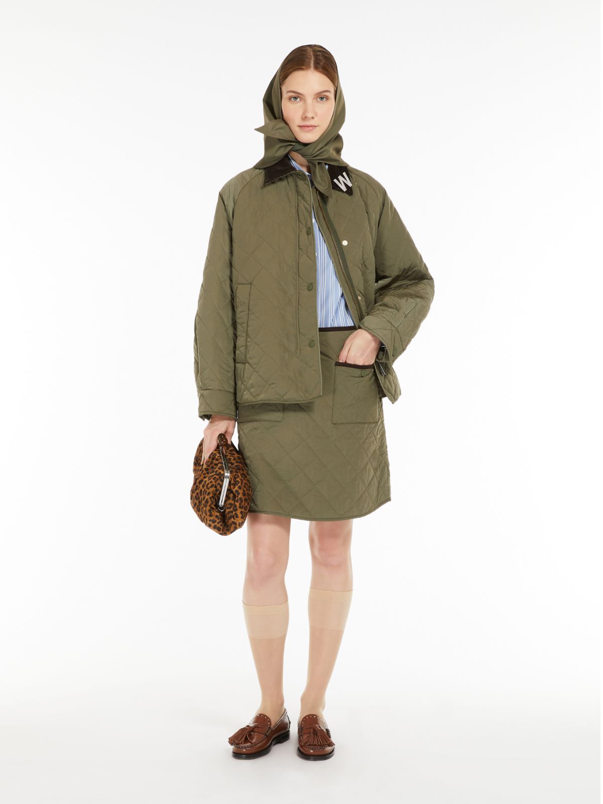 Woman wearing a green coat with a hood on a white background