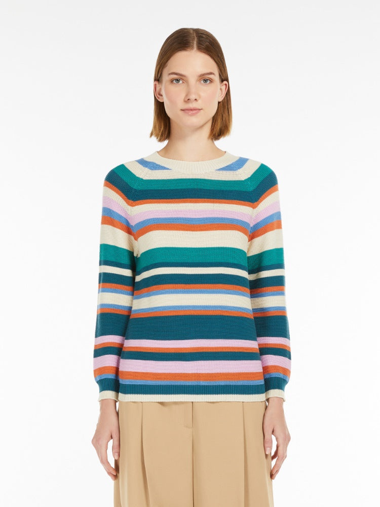 Woman wearing a colorful striped sweater on a white background