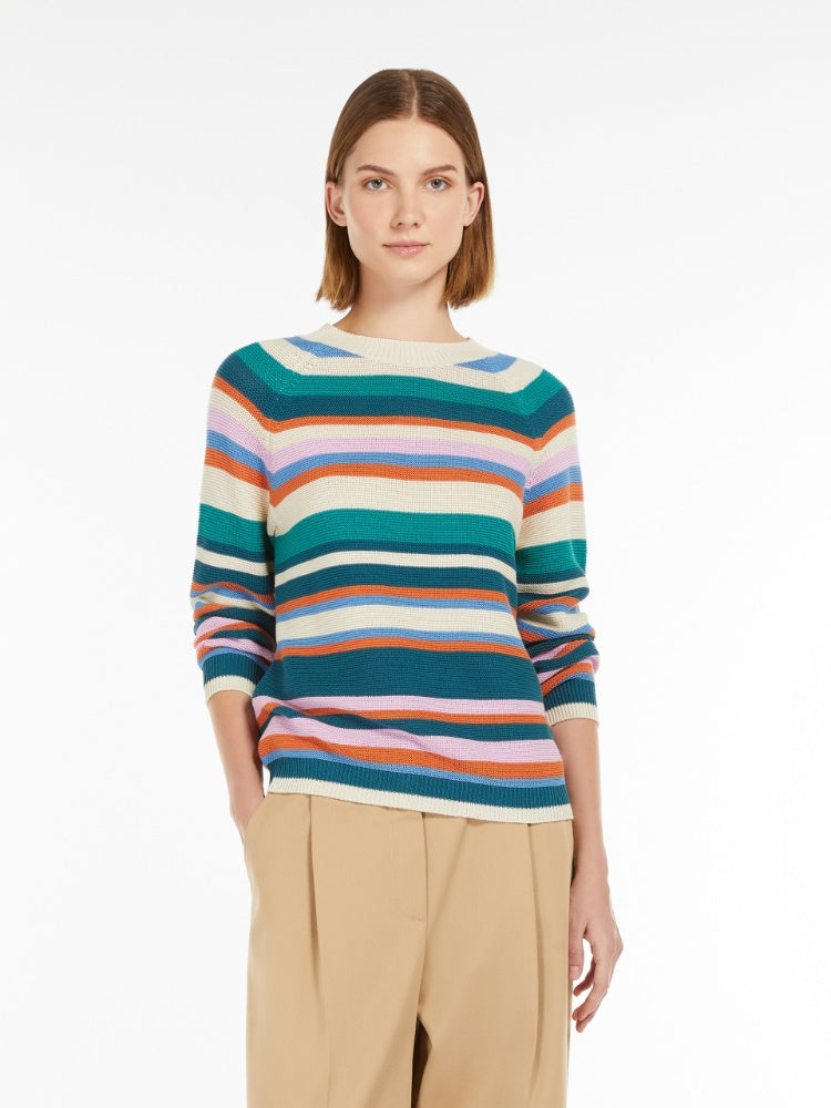 Woman wearing a colorful striped sweater on a white background