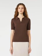 Woman wearing a brown polo shirt against a white background
