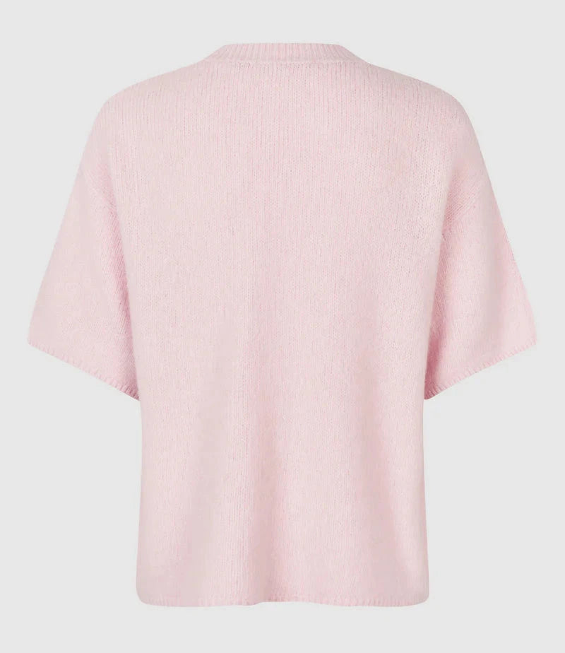 Pink sweater on a light gray background