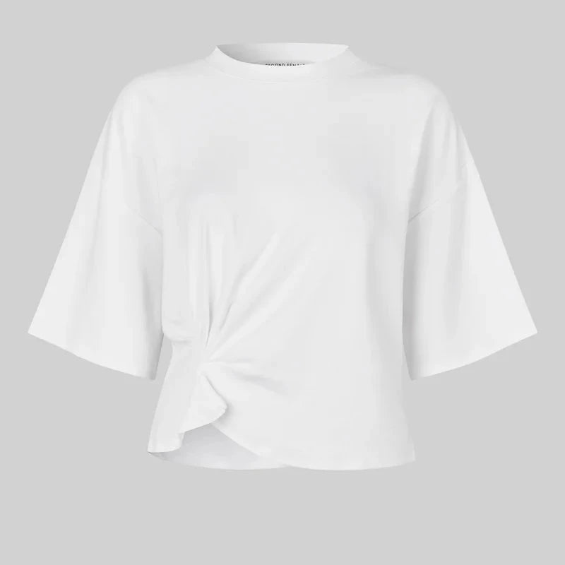 White blouse with a knot detail on a gray background