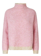Pink textured sweater with a light border on a gray background