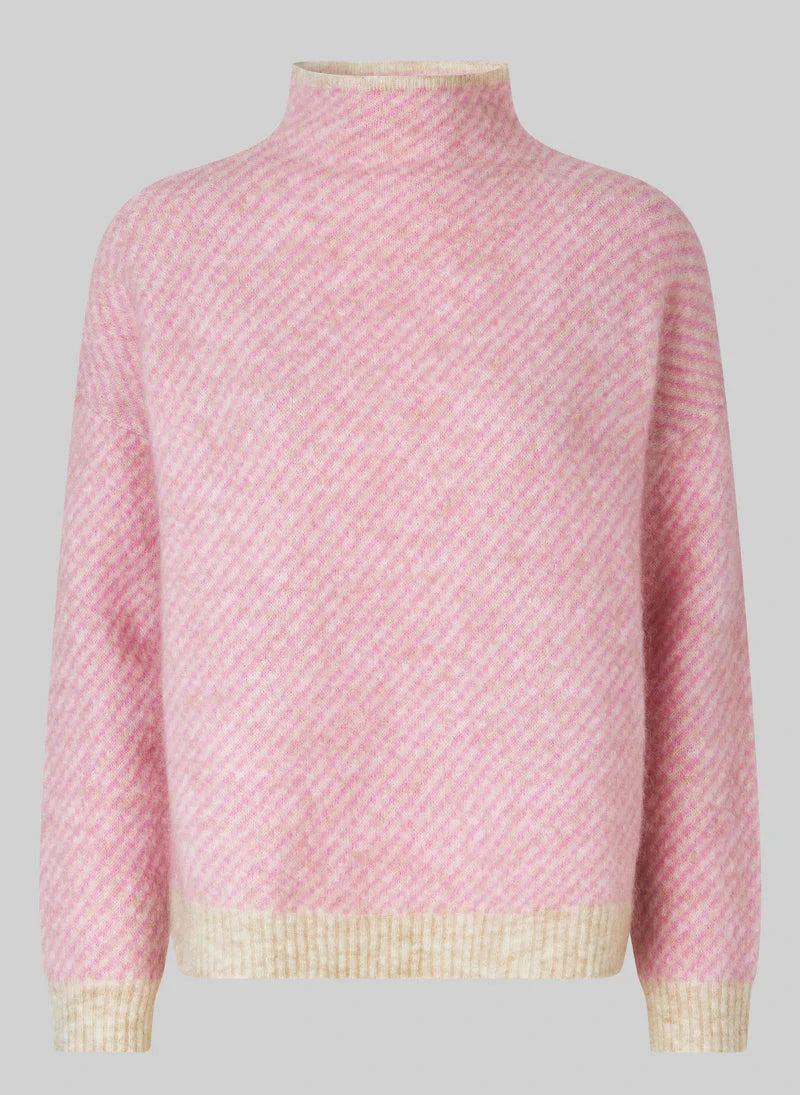 Pink textured sweater with a light border on a gray background