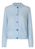 Light blue cardigan with button details on a light gray background