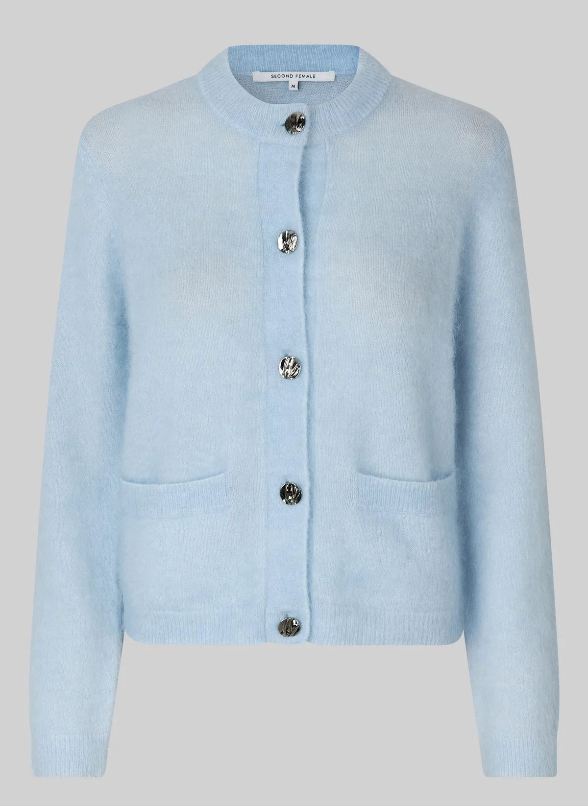 Light blue cardigan with button details on a light gray background