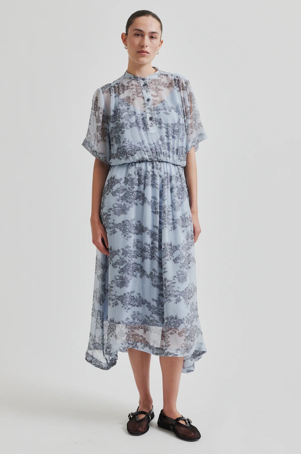 Woman wearing a floral dress on a white background