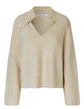 Beige knitted sweater on a light gray background