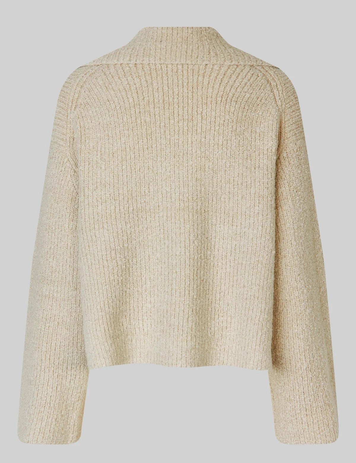 Beige knitted cardigan on a light gray background