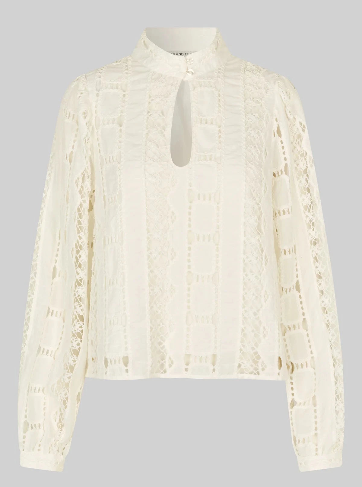 White lace blouse on a gray background
