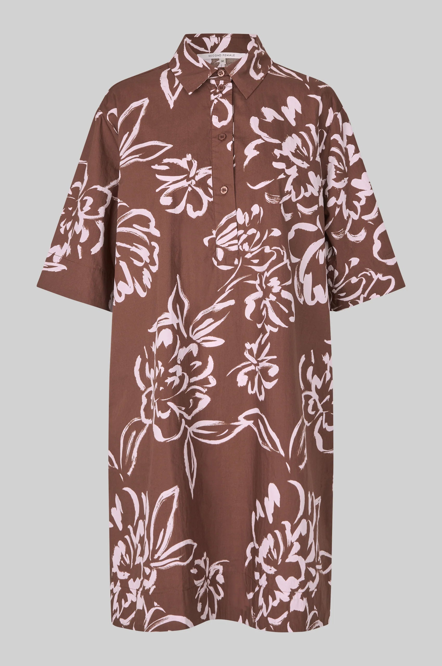 Brown dress with white floral pattern on a gray background