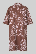 Brown dress with white floral pattern on a gray background