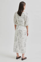 Woman wearing a floral dress on a white background