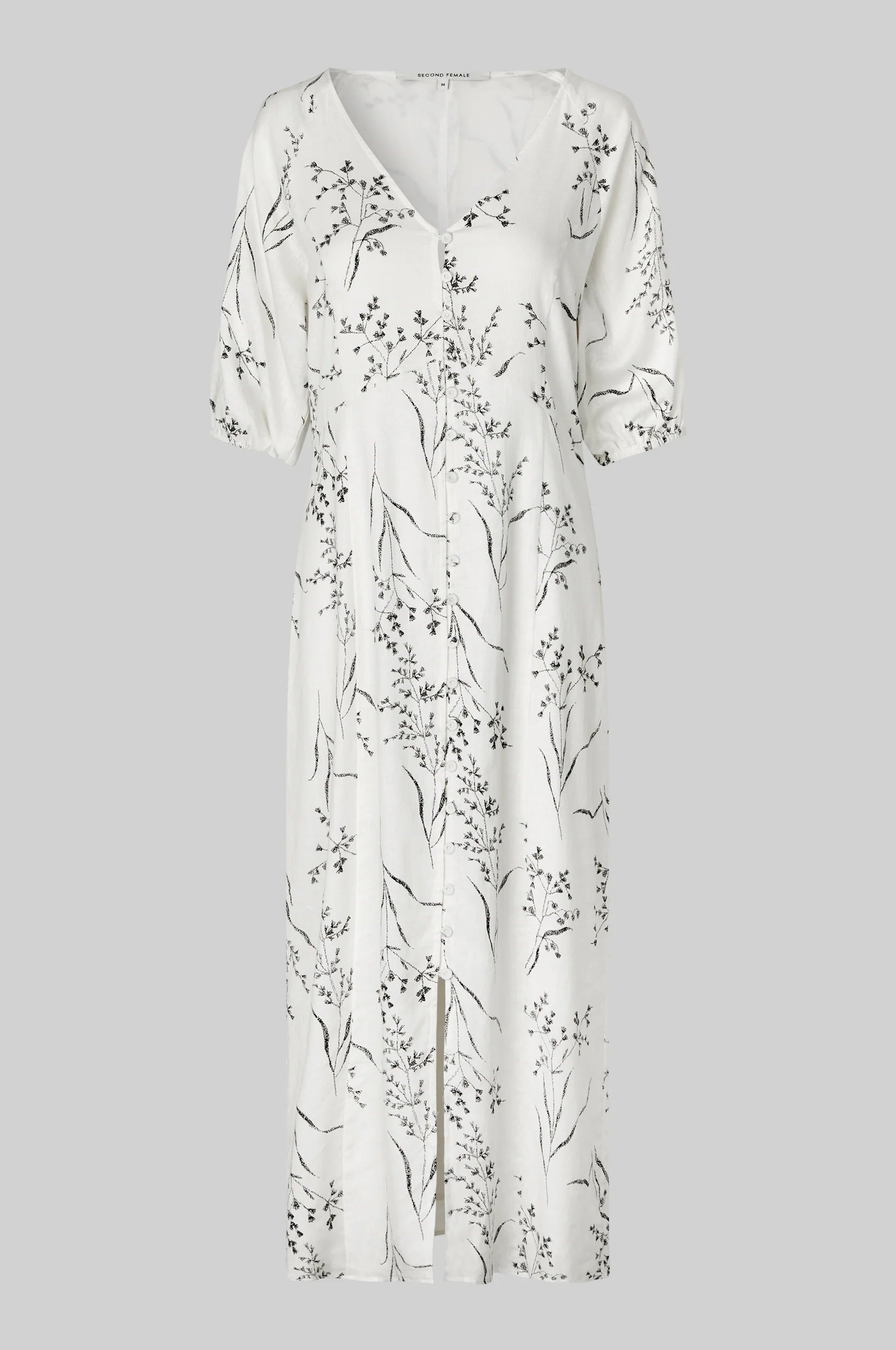 White dress with floral pattern on a gray background