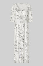 White dress with floral pattern on a gray background