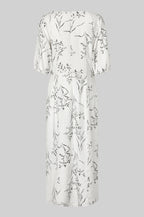 White dress with floral pattern on a gray background
