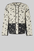 Black and white patterned jacket on a light gray background