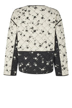 Quilted jacket with black floral pattern on a gray background