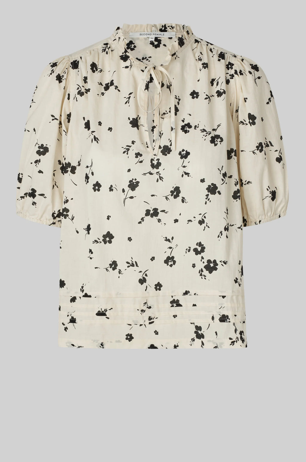 Floral blouse with puff sleeves on a light gray background