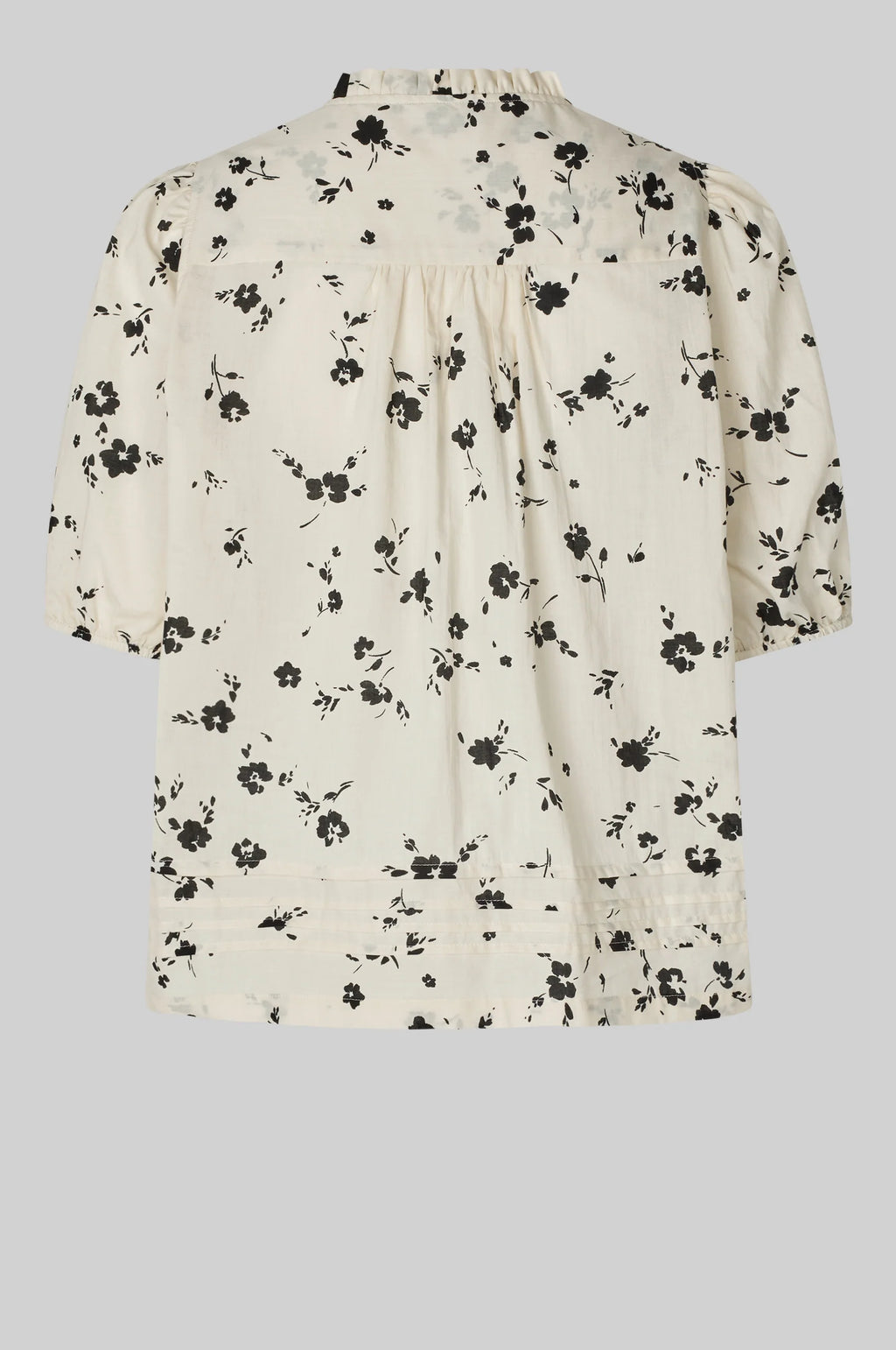 Floral blouse with black flowers on a white background