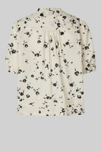 Floral blouse with black flowers on a white background