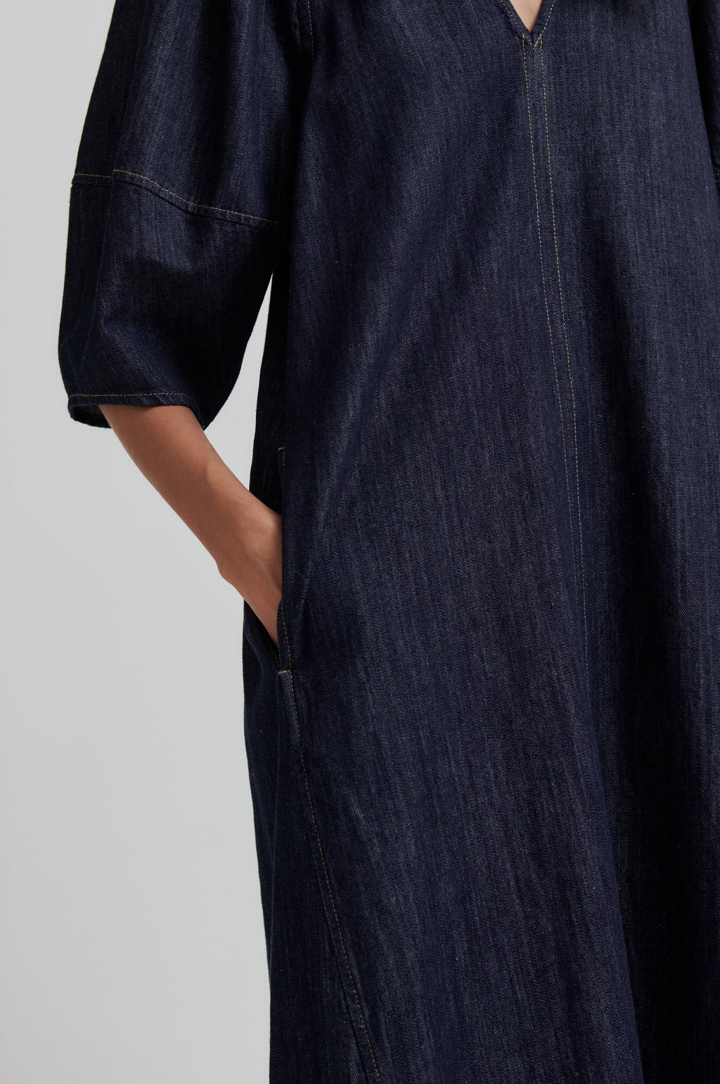 Dark denim dress with a plain background