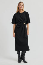 Woman wearing a black dress with a belt on a white background