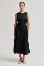 Woman wearing a black sleeveless dress on a white background