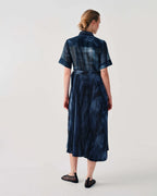 Woman wearing a blue patterned dress on a white background