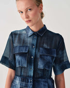 Woman wearing a blue denim outfit on a white background