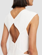 White sleeveless top with cut-out design on a plain background