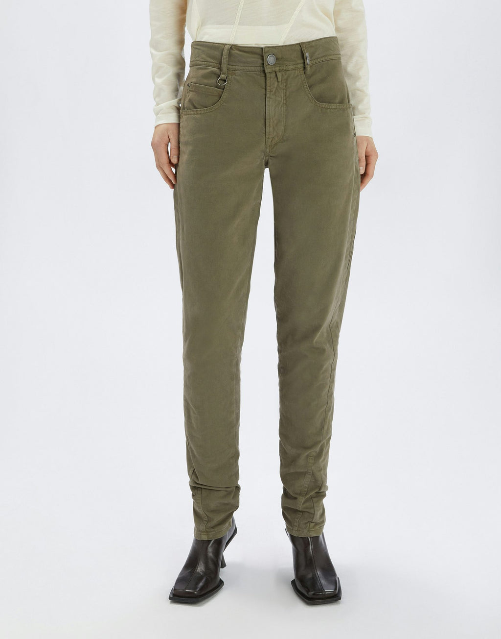 Person wearing olive green pants on a white background