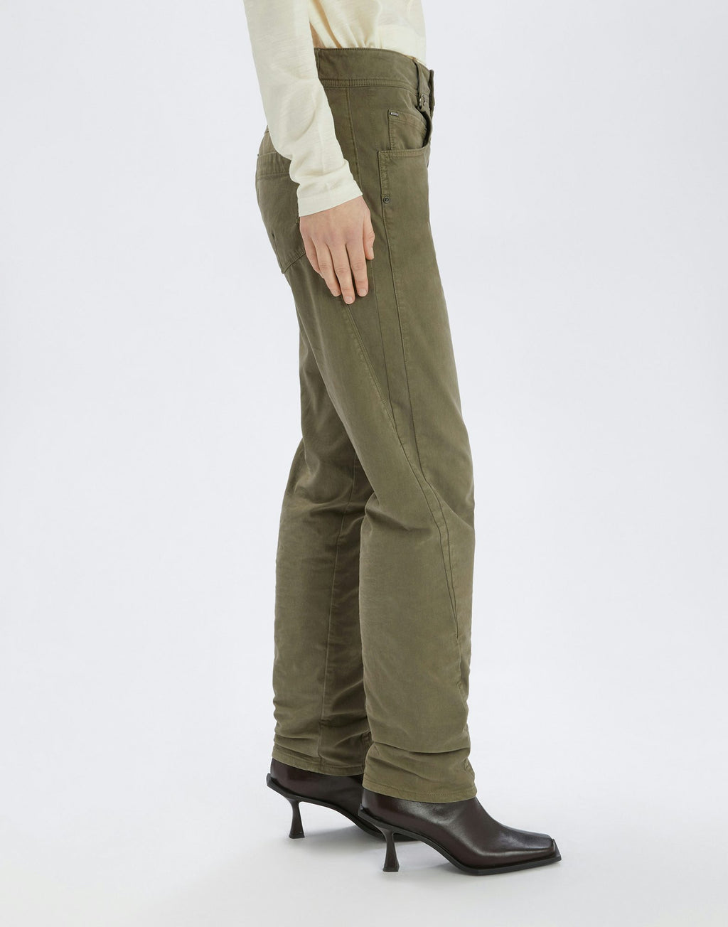 Person wearing olive green pants on a white background