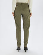 Person wearing olive green pants on a white background