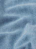 Close-up of blue denim fabric with visible texture