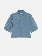 Blue denim shirt on a light blue background