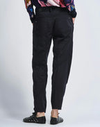 Person wearing black pants on a white background