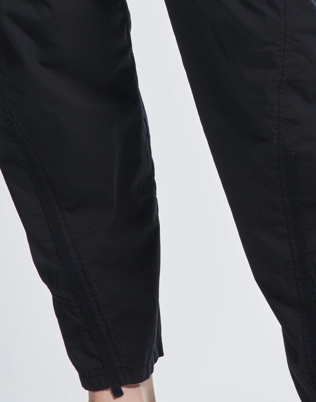 Close-up of black pants on a light gray background