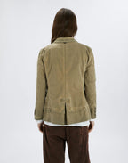 Person wearing a beige jacket on a white background