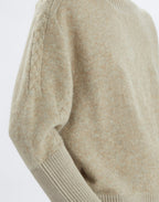 Close-up of a beige sweater on a white background