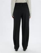 Black pants worn by a person on a white background