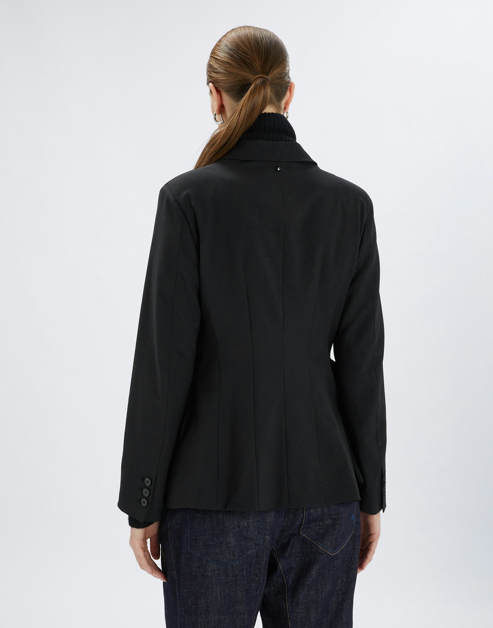 Person wearing a black jacket on a white background