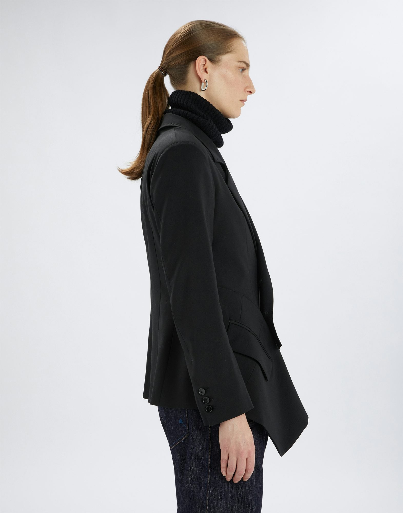 Person wearing a black coat on a white background