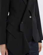 Black blazer worn by a person on a white background