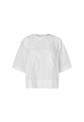 White short-sleeve blouse with 3D floral applique detailing on the chest and shoulders, displayed against a light gray background.