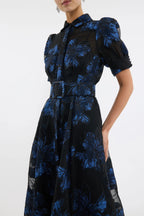 Black dress with blue floral pattern on a white background