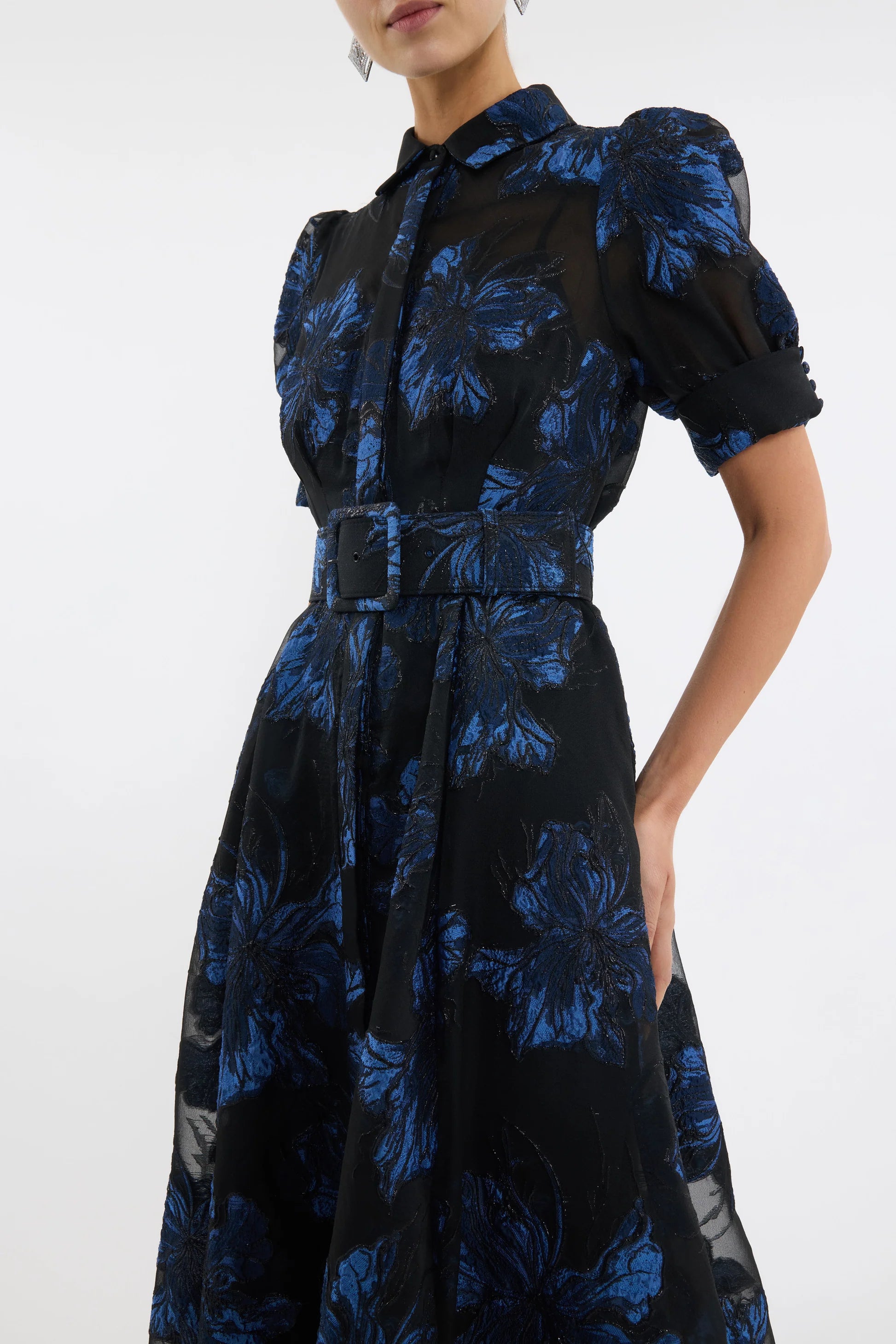 Black dress with blue floral pattern on a white background