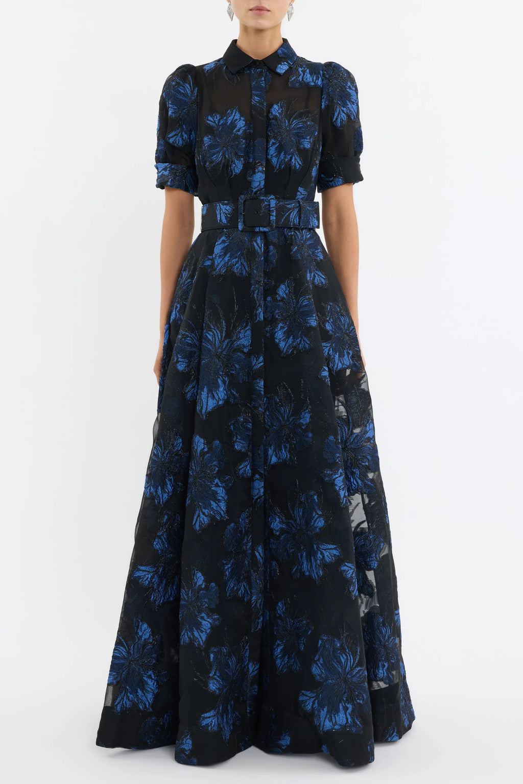 Woman wearing a black and blue floral dress on a white background