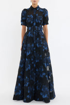 Woman wearing a black and blue floral dress on a white background